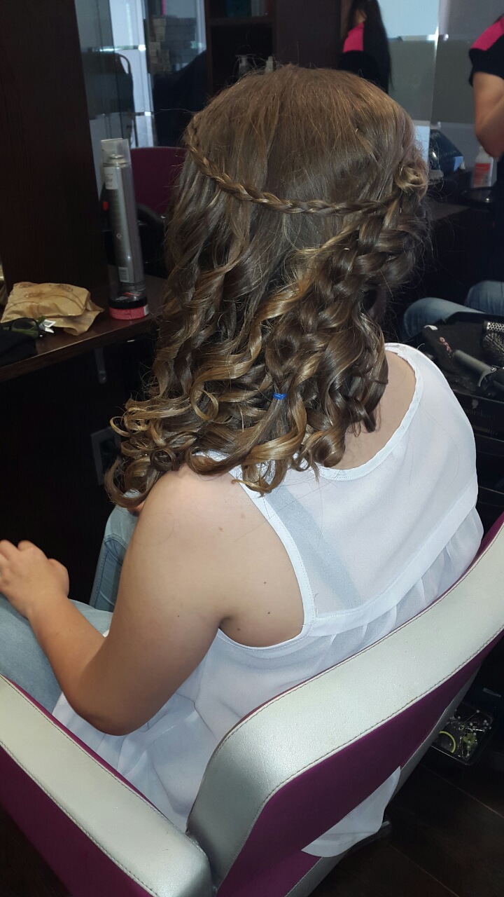 Client with styled hair in a salon chair